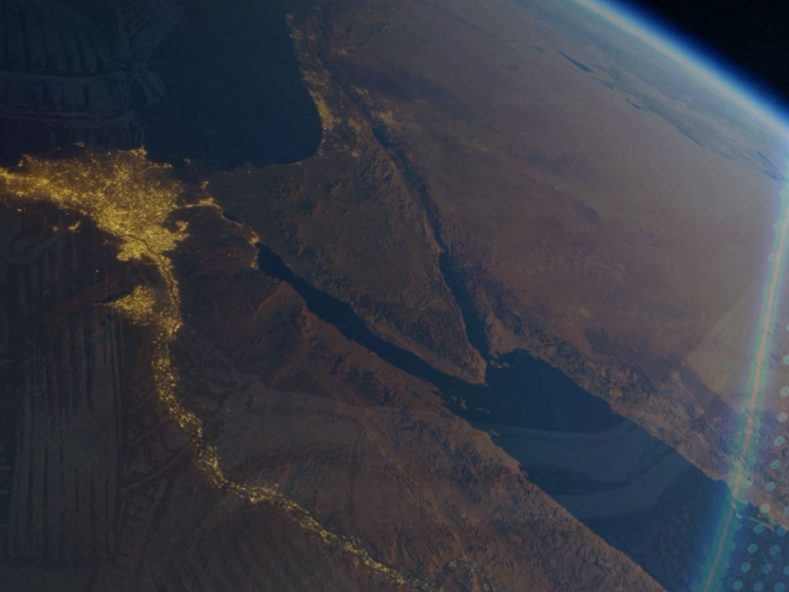 Two men holding hands wearing pride bracelets.