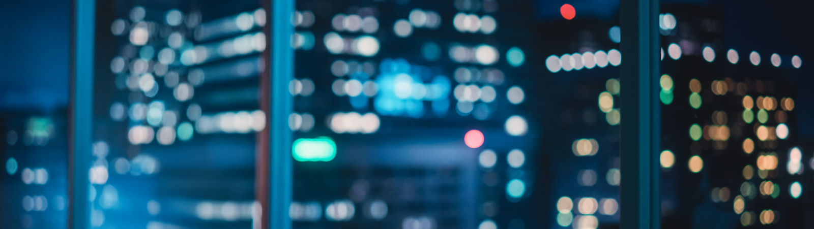 Person holding pen over papers on a table.