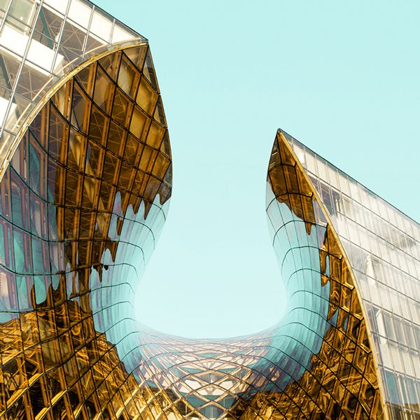 Person holding pen over papers on a table.